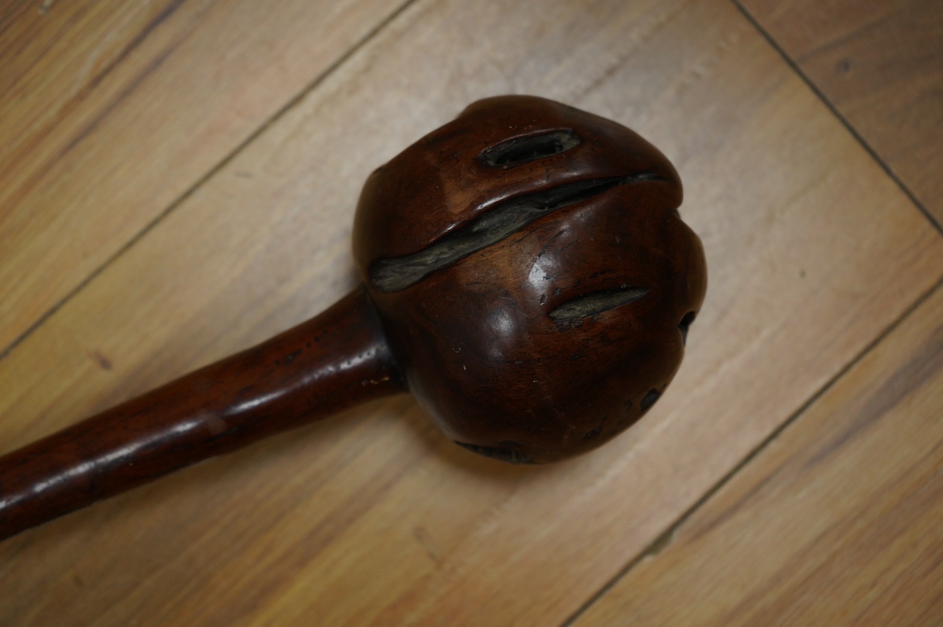 A 19th century Fiji hardwood throwing club, Ula, 39cm long, bulbous head with incisions, the grip carved with zigzag decoration. Condition - good, formerly with bone inlay to the head